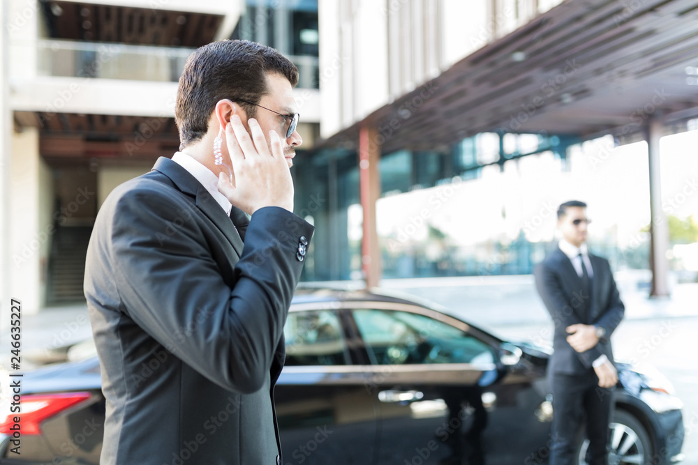 Bodyguard Getting Information About Arrival Of Boss